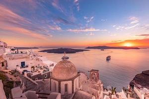 Amazing evening view of Santorini island. Picturesque spring sunset on the famous Fira village, Greece, Europe. Traveling concept background. Artistic inspirational sunset landscape, dream vacation photo