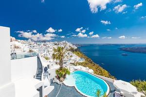 White architecture on Santorini island, Greece. Swimming pool in luxury hotel. Beautiful view, sky over blue sea. Summer vacation and holiday as travel destination concept, amazing tourism background photo