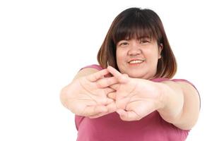 Fat Asian woman smiling brightly. Exercise arm stretching Stay on a white background. The concept of losing weight, fat burning, exercise to stay healthy. Copy space photo