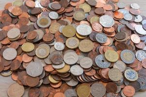 A pile of coins from around the world. photo