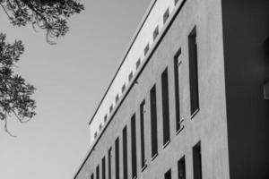 grayscale shot of a facade of modern building photo