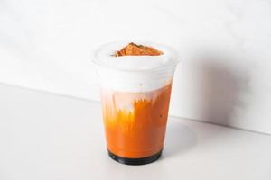 Thai tea with milk and bael on top photo