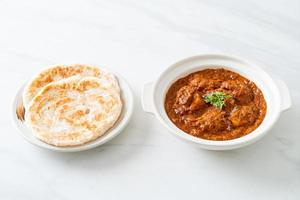 chicken tikka masala spicy curry meat food with roti or naan bread photo