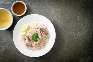 Hainanese Chicken Rice or steamed rice with chicken photo