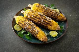 barbecue and grilled corn with cheese and lime photo