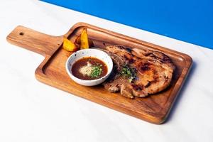 grilled pork chop steak with spicy jaew sauce photo