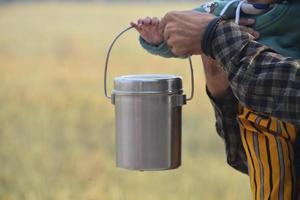 Steel milk tiffin in hand photo