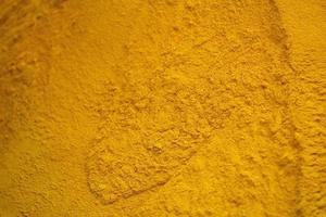 turmeric powder background yellow detail photo