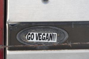 go vegan sticker on old car photo