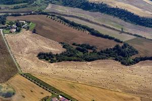 many hay balls on farmed fields aerial view panorama photo