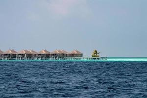 maldives on water bungalow resort view from ocean photo