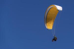 paragliding hang glider in the blue sky photo