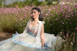 Outdoor portrait girl in the flowers garden, teenage asian girl photo