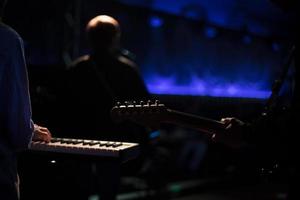 Musicians on stage. Playing musical instruments. Rock band performance. photo