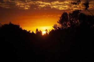 Sunset. Dawn in morning. Warm light in sky. Heavenly landscape in village. photo