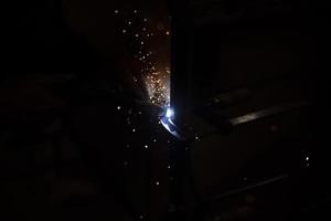 Metal welding in dark High temperature heating steel. Metal lights. photo