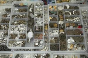 Decorations in box. Lots of small jewelry for women. Box with small items. photo