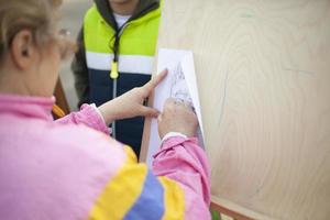 Artist draws. Person learns to draw. Details of drawing on easel. photo