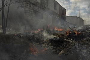 Black smoke from fire. Burning of garbage. Destruction of nature. Environmental disaster. photo