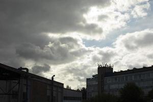 Sky over city. Clouds and buildings. Landscape in summer. photo