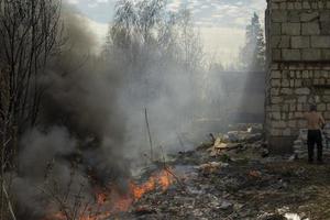 Black smoke from fire. Burning of garbage. Destruction of nature. Environmental disaster. photo