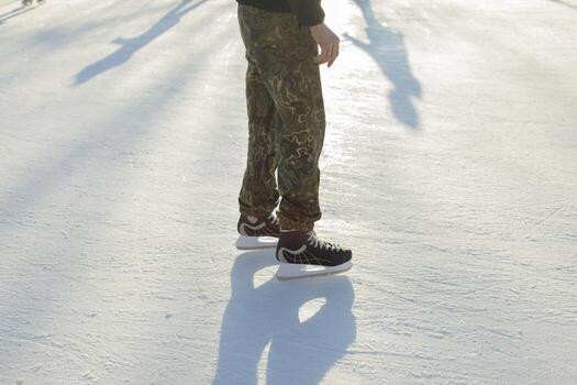 Man on roll on ice. Winter holidays. Sharp skates for skating. photo