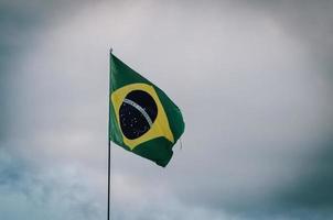 Brazil flag waving in a pole with cloudy sky photo