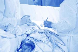 Surgeons perform an operation on a man.Medical background of the operating room. photo