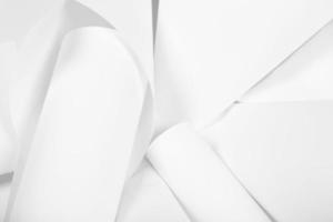 White sheets of office paper are twisted and scattered. Paper white abstract background. photo