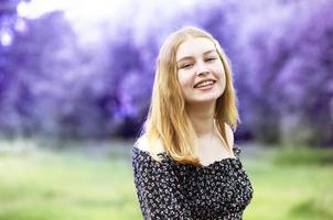 Happy young girl on a lilac summer background. photo