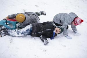 Children in winter. Boys friends are sledding. photo