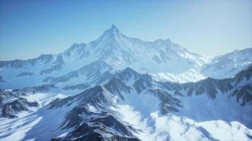 Scenic view on snowy Matterhorn peak in sunny day with blue sky photo