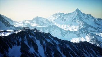 Aerial View from Airplane of Blue Snow Covered Canadian Mountain Landscape photo