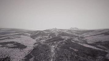 Dramatic winter dark desert steppe on a highland mountain plateau photo