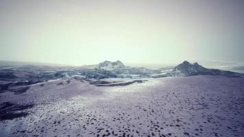 Dramatic winter dark desert steppe on a highland mountain plateau photo