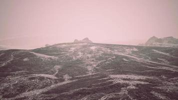 Dramatic winter dark desert steppe on a highland mountain plateau photo