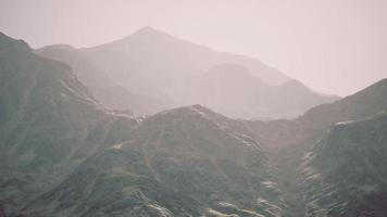 View of the Afghan mountains in fog photo