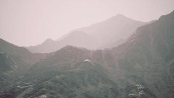 View of the Afghan mountains in fog photo