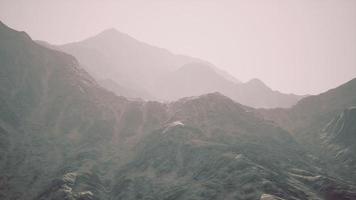 View of the Afghan mountains in fog photo