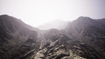 View of the Afghan mountains in fog photo