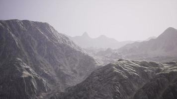 View of the Afghan mountains in fog photo