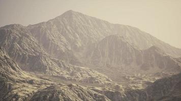 View of the Afghan mountains in fog photo