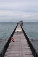 Fishing piers or boardwalk jetty at the seaside or resort being closed at the moment. photo