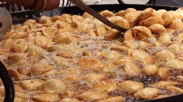 Close-up video of deep-frying kachori on the streets of New Delhi.