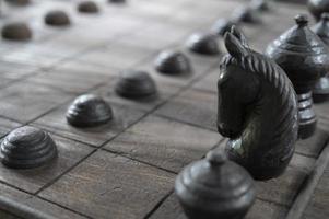 Ancient chess pieces made of wood photo