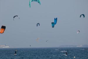 windsurfing, kitesurfing, water and wind sports powered by sails or kites photo