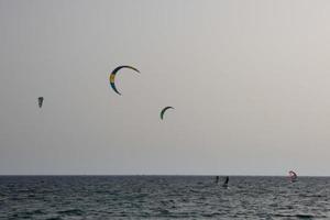 windsurfing, kitesurfing, water and wind sports powered by sails or kites photo