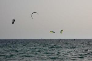 windsurfing, kitesurfing, water and wind sports powered by sails or kites photo