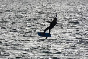 windsurfing, kitesurfing, water and wind sports powered by sails or kites photo