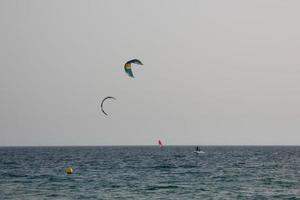 windsurfing, kitesurfing, water and wind sports powered by sails or kites photo